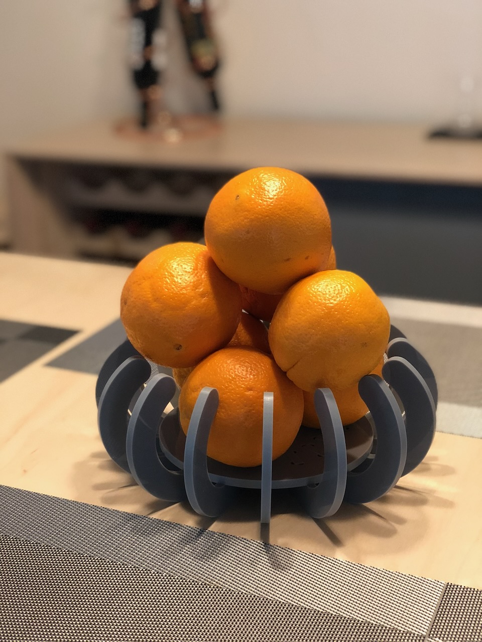 Laser-cut acrylic segmented fruit bowl with oranges